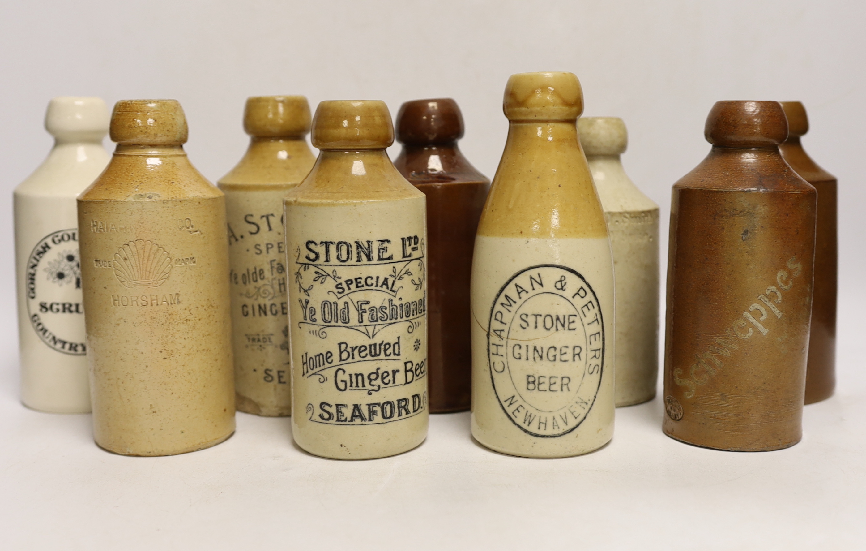 Early 20th century stoneware ginger beer bottles, one Hurstpierpoint, one Horsham, two Seaford and four others